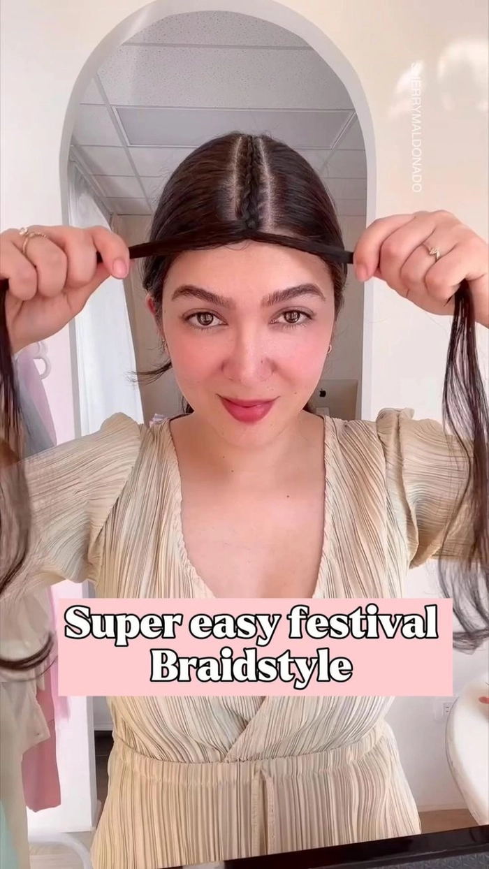 A woman wearing a bohemian braided crown at a music festival, with loose waves and floral accents