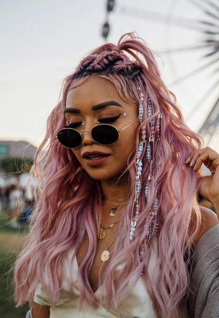 Woman with long hair styled in a bohemian braided crown at a music festival