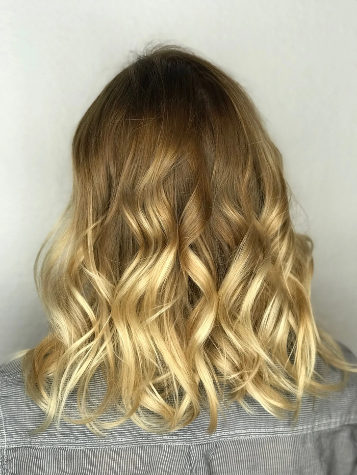 Elegant party hairstyle featuring balayage highlights and color melt Party hairstyle with balayage color melt for a glamorous event look