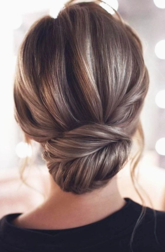 Party hairstyle image 7: French twist updo for formal gowns Elegant party French twist updo styled with formal gown, side view