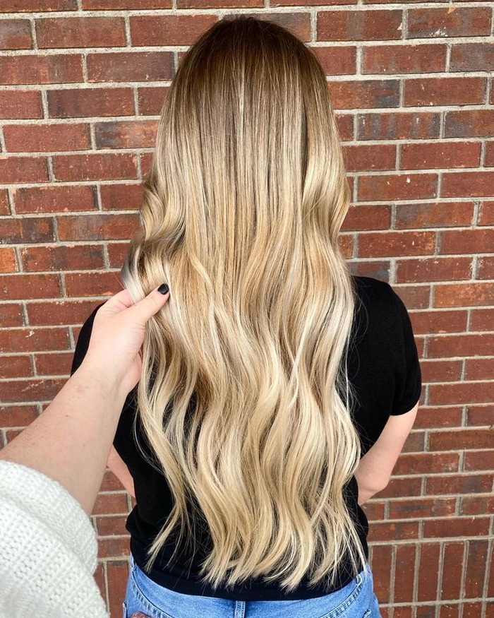 Stunning party hairstyle with balayage color melt for elegant occasions Party hairstyle featuring a balayage color melt with blended highlights at a festive event