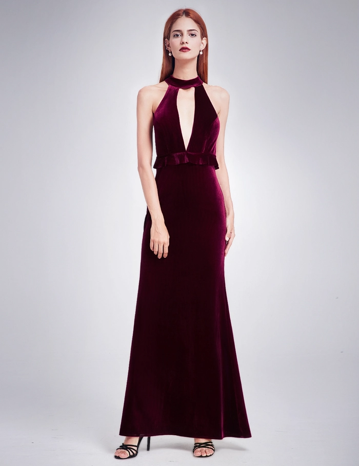Elegant updo hairstyle complementing a high neck velvet gown for evening parties