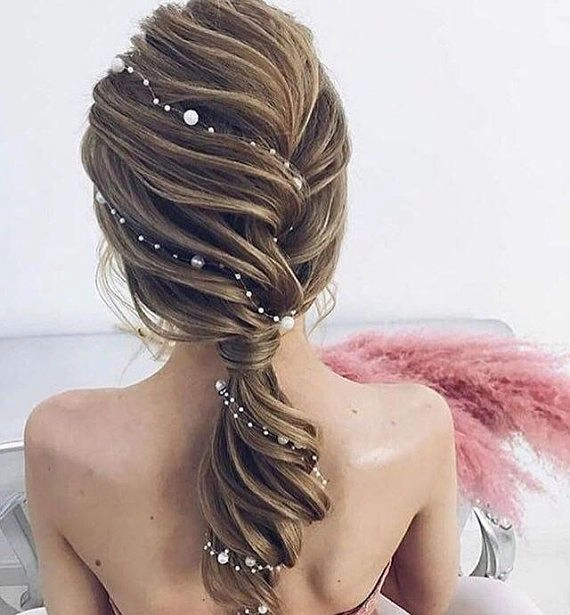 Elegant party hairstyle with pearl hair vines woven through a chic updo