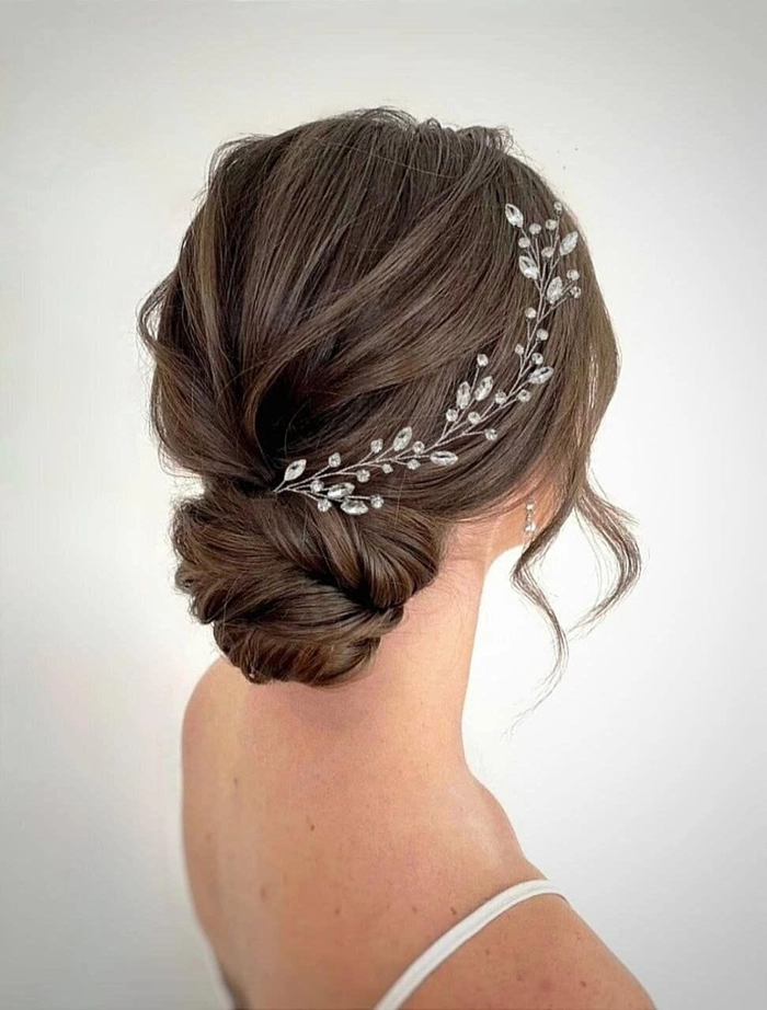 Elegant party updo with pearl hair vines woven through curls