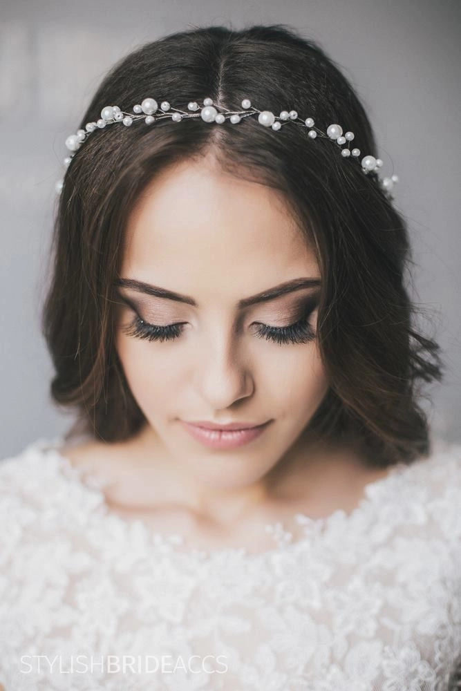Elegant party hairstyle with delicate pearl hair vines woven through