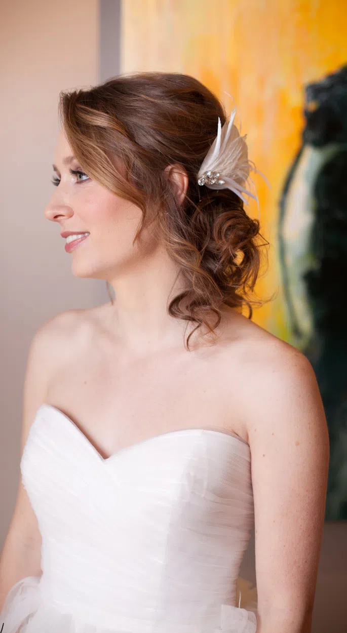Woman with an elegant updo hairstyle wearing a strapless sequin dress at a party