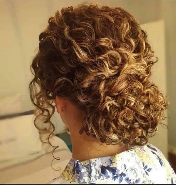 Elegant updo for tightly curled natural hair at a festive party Party updo on natural tight curl pattern hair with volume and elegance
