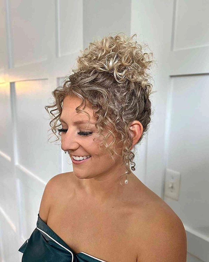Elegant party updo designed for natural tight curl pattern hair Party updo hairstyle for natural tight curl pattern with elegant accessories