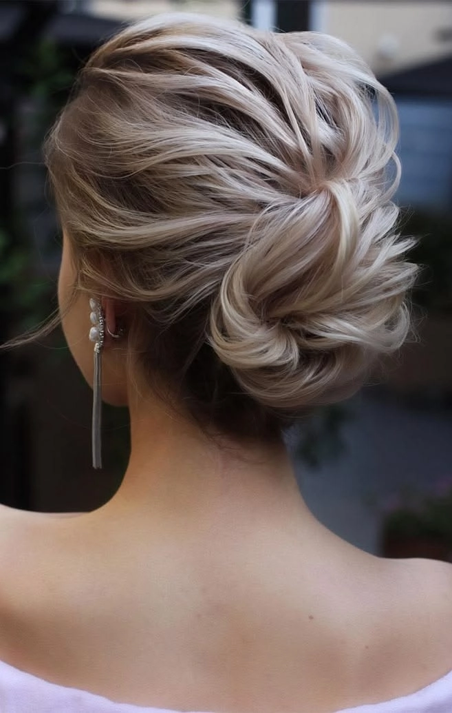 Chic wedding guest updo featuring pastel pink hair Pastel pink hair in a sophisticated updo perfect for wedding guests