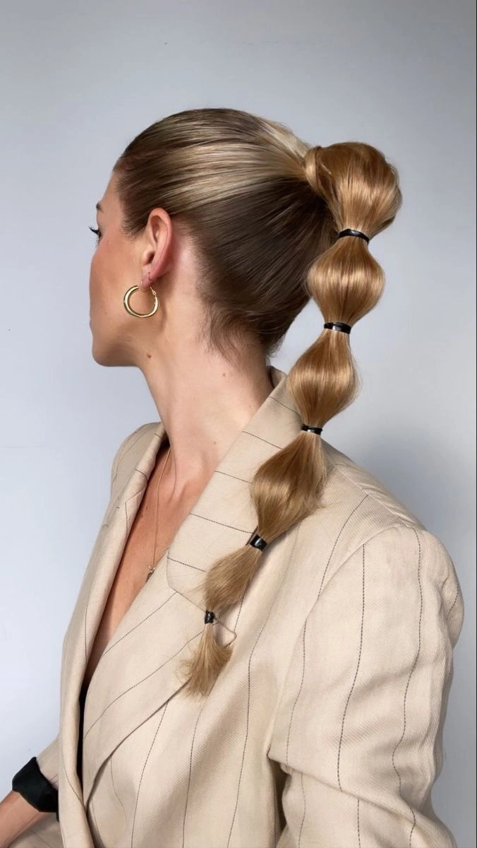Prom bubble ponytails hairstyle for a modern party style Modern prom hairstyle with bubble ponytails for a party look