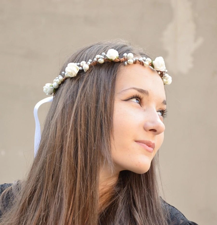Prom hairstyle featuring a fresh flower crown seamlessly woven into the look Prom updo hairstyle with fresh flower crown integrated into the curls