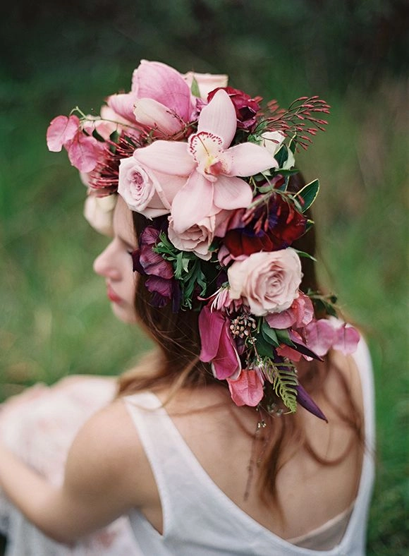 Prom hair with fresh flower crown integration for a romantic party look Prom hairstyle featuring fresh flower crown woven into curly updo