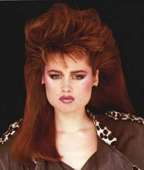 Woman with big, teased retro eighties party hairstyle featuring high volume and curls