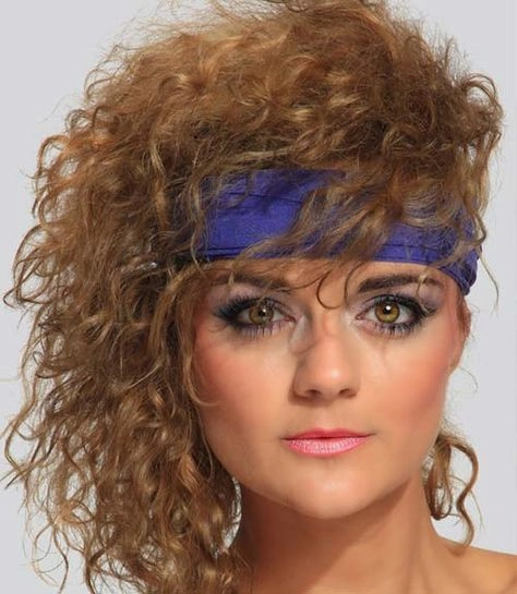 Woman with a towering teased hairstyle and voluminous curls from the eighties party era