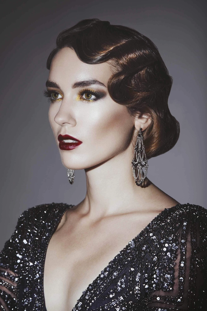 Woman with vintage Great Gatsby party hairstyle featuring sculpted finger waves