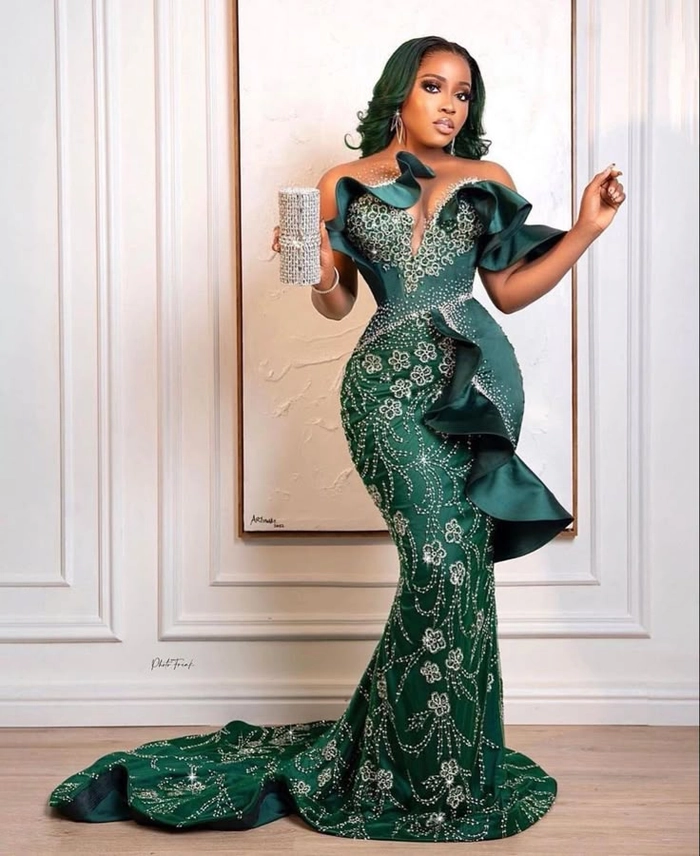 Elegant updo hairstyle complementing a heavy beaded formal gown for a wedding guest