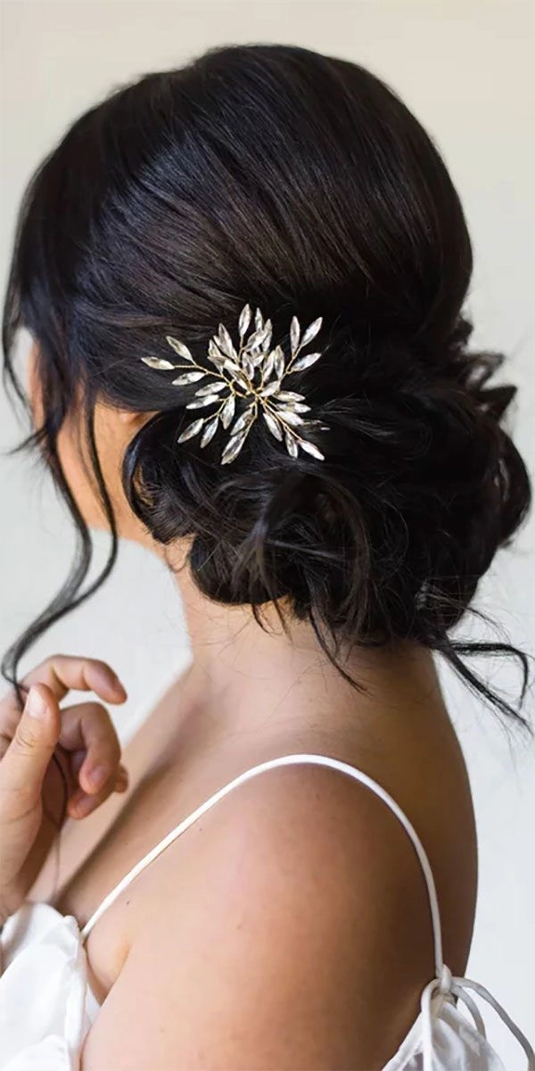 Wedding guest hairstyle accented with sparkling crystal hairpins for party elegance