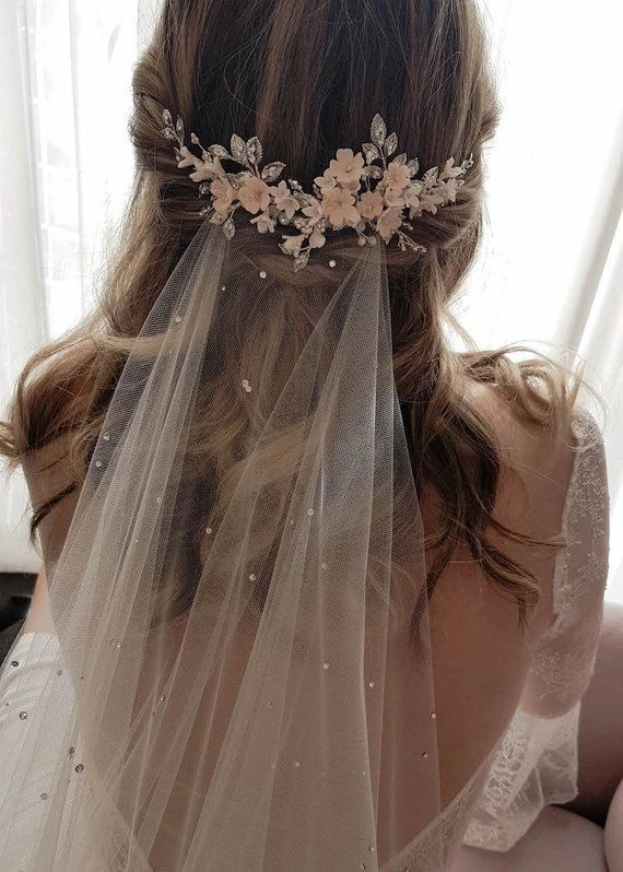 Elegant wedding guest hairstyle adorned with crystal hairpins