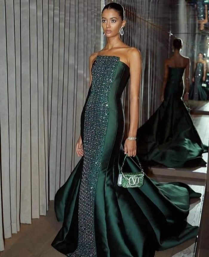Elegant updo hairstyle complementing a heavy beaded formal gown for a wedding guest