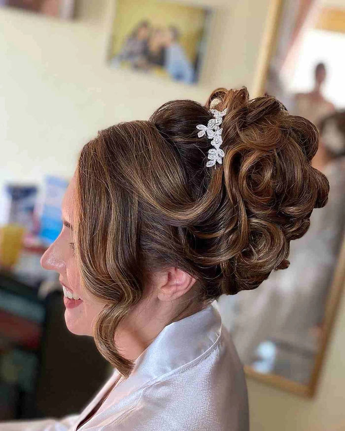 Elegant pastel pink updo hairstyle perfect for a wedding guest with pastel hair Pastel pink hair styled in an elegant updo with delicate floral accents for a wedding guest look