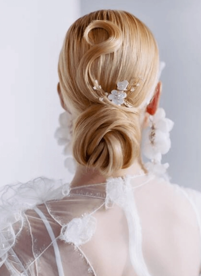 Elegant updo hairstyle for pastel pink hair at a formal party event Romantic pastel pink hair updo with delicate floral accents for a wedding guest