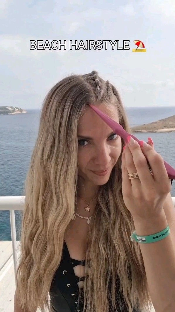 A woman at a beach party with a wind-proof braided updo and soft waves, perfect for outdoor events