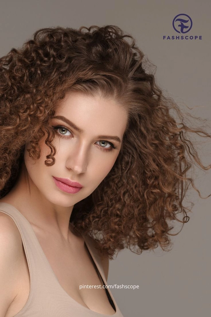 Elegant winter gala updo showcasing medium curly hair with sparkling hairpins and soft volume.