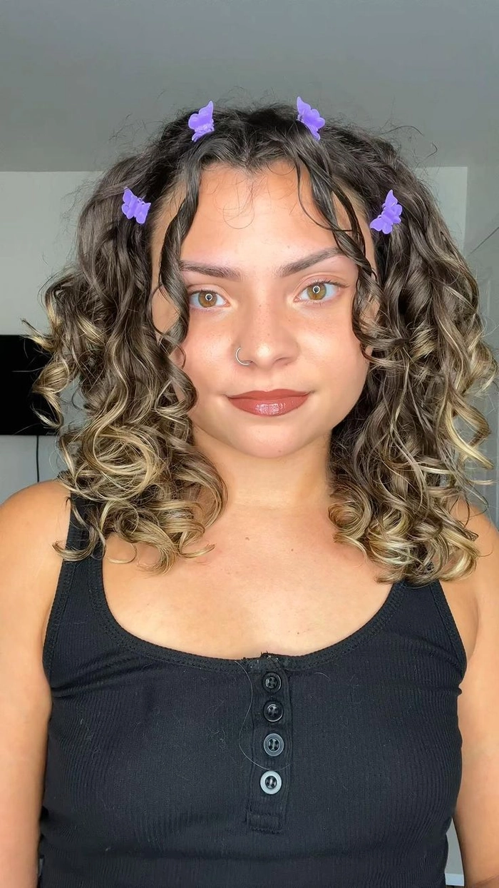 y2k clubbing hairstyle with colorful butterfly clips in high ponytail