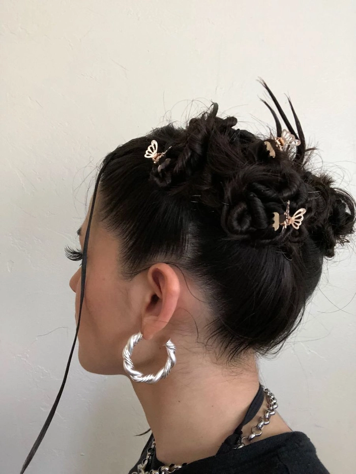 Retro Y2K clubbing hairstyle with colorful butterfly clips and voluminous waves
