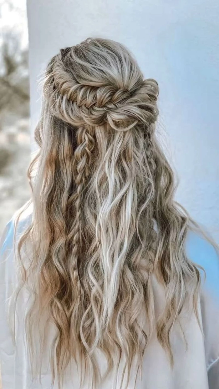Boho chic prom hairstyle featuring loose waves and delicate floral accessories