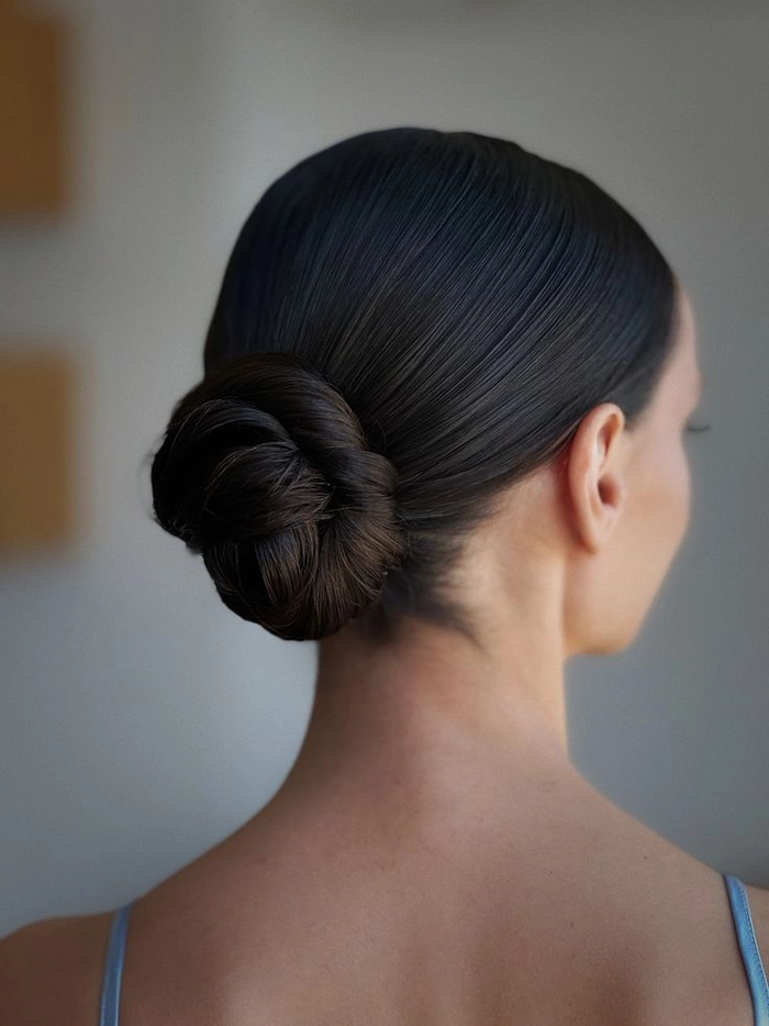 Classic ballet bun hairstyle perfect for prom elegance and grace Elegant classic ballet bun prom hairstyle with smooth finish
