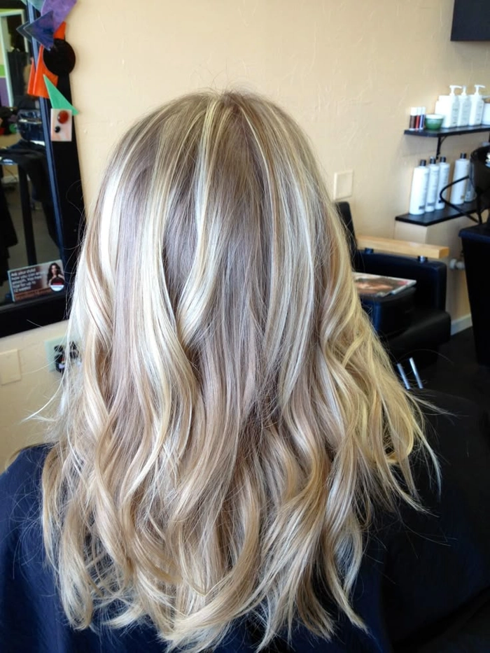 Elegant prom hairstyle featuring ash blonde highlights with loose curls