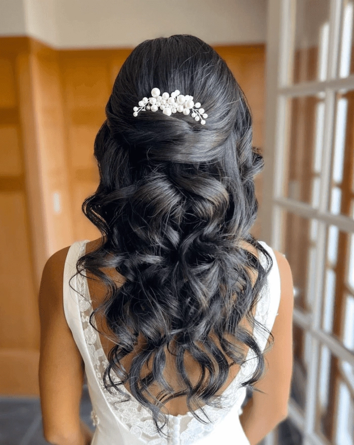 Elegant voluminous blowout prom hairstyle with soft curls and glossy finish