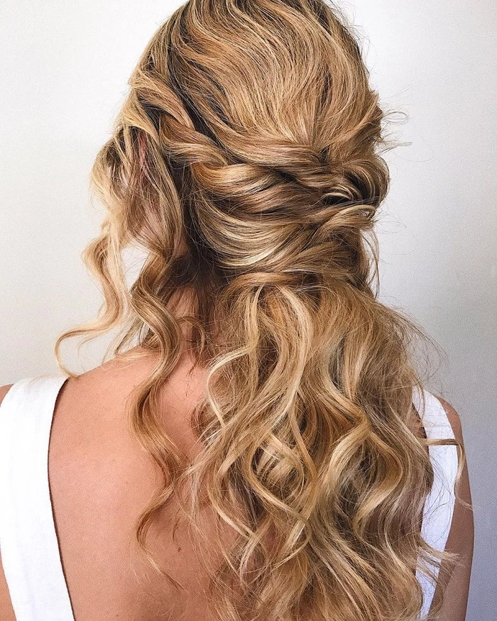 Elegant braided prom hairstyle perfect for a rustic barn venue setting