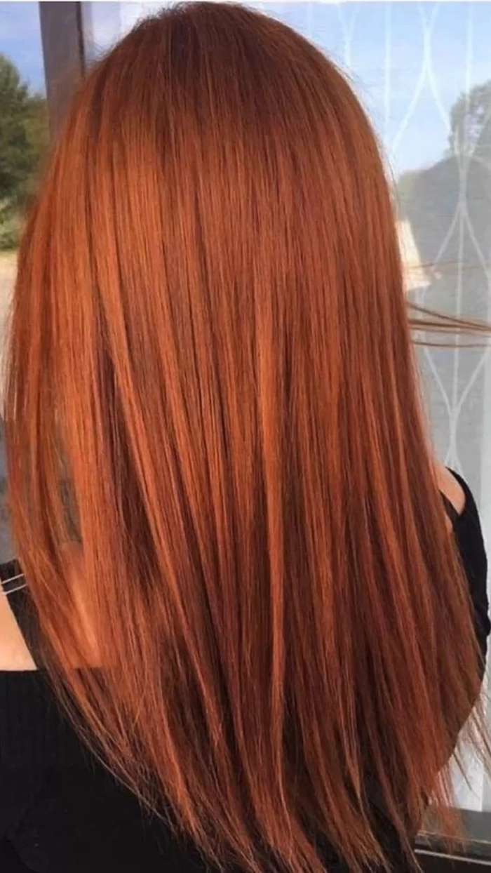 Elegant prom hairstyle showcasing copper ginger hair with soft curls