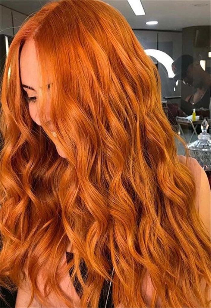 Elegant prom hairstyle for copper ginger hair with soft curls and floral accessories