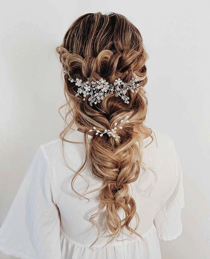Elegant prom hairstyle featuring a fishtail braid cascading to one side
