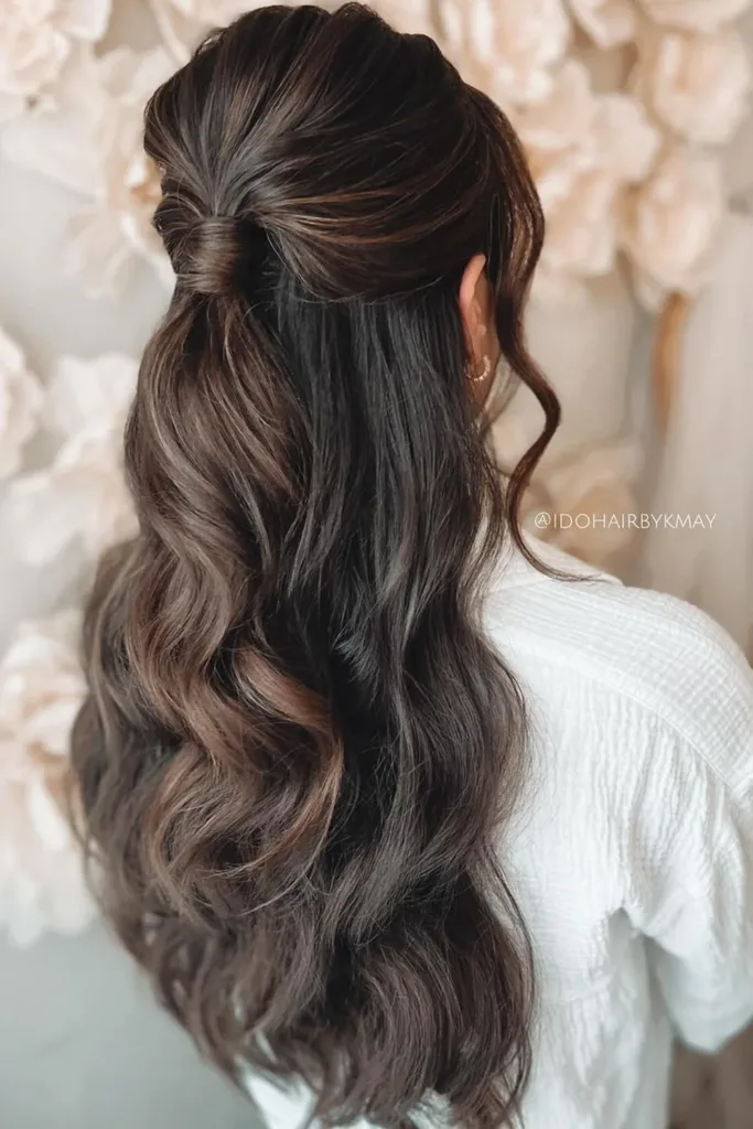 Gorgeous curled half up half down prom hairstyle perfect for celebrations Elegant half up half down prom hairstyle featuring soft curls