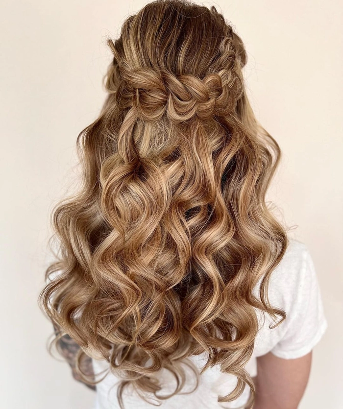 Chic curly half up half down prom hairstyle for a glamorous look Elegant half up half down prom hairstyle featuring soft curls