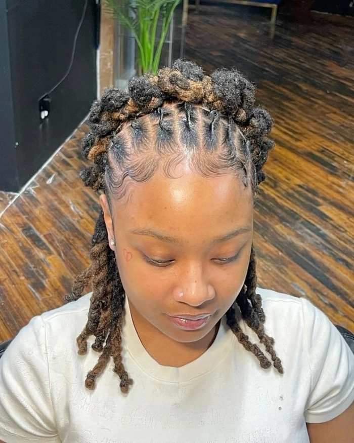 Elegant prom hairstyle featuring locs styled with intricate braids and jewels