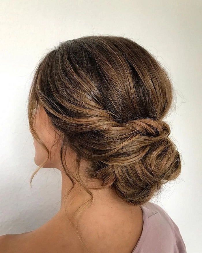 Sophisticated low chignon hairstyle perfect for prom and formal events Elegant low chignon prom updo with smooth finish and delicate accessories