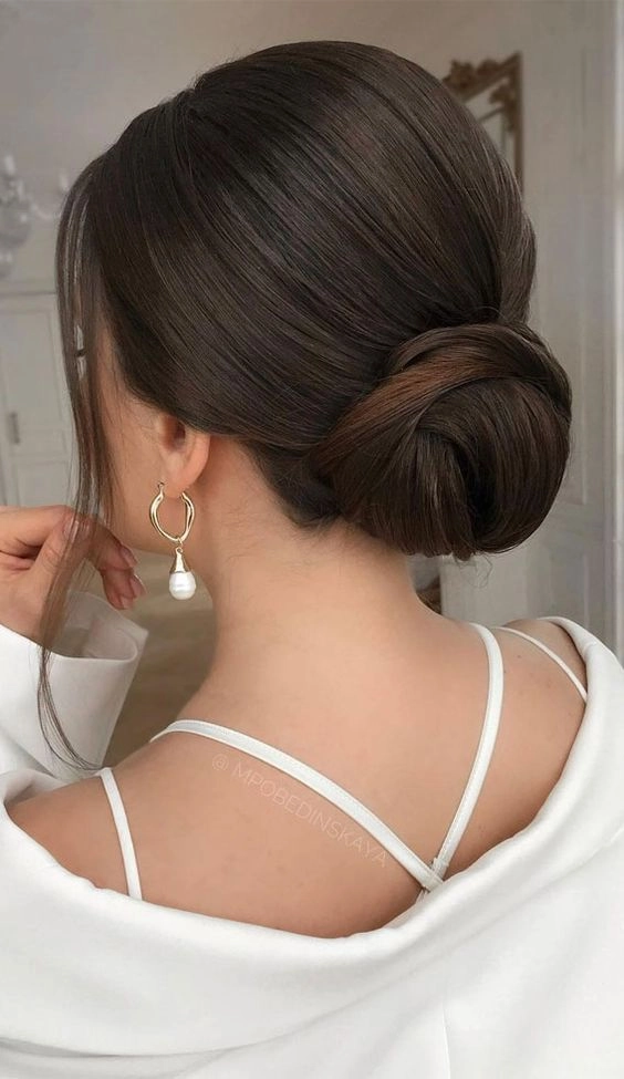 Chic and timeless low chignon hairstyle perfect for prom nights Elegant low chignon prom updo showcasing a sleek and sophisticated style