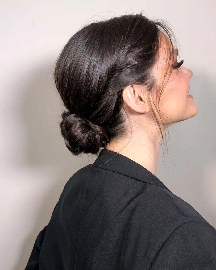 Elegant prom hairstyle featuring a low nape bun with soft curls