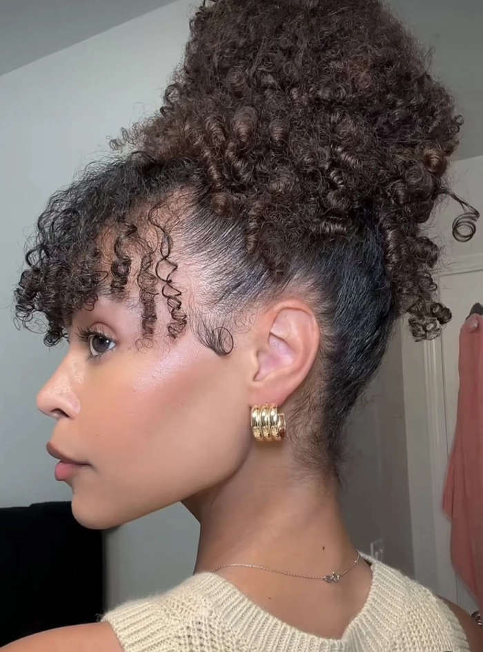 Elegant prom hairstyle showcasing tightly coiled natural hair styled in an updo with decorative accessories