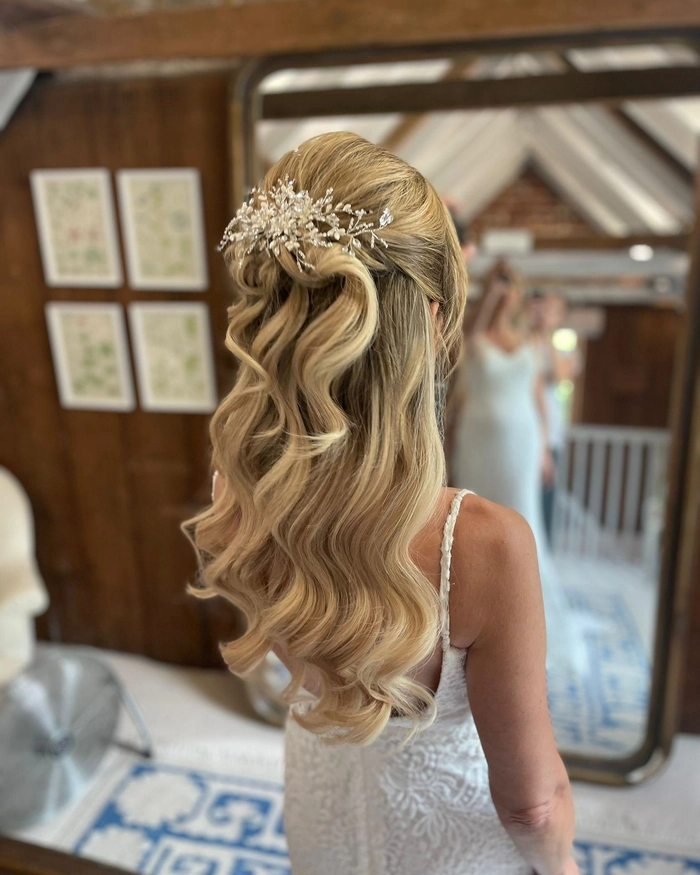 Elegant prom hairstyle featuring platinum blonde hair styled in loose waves
