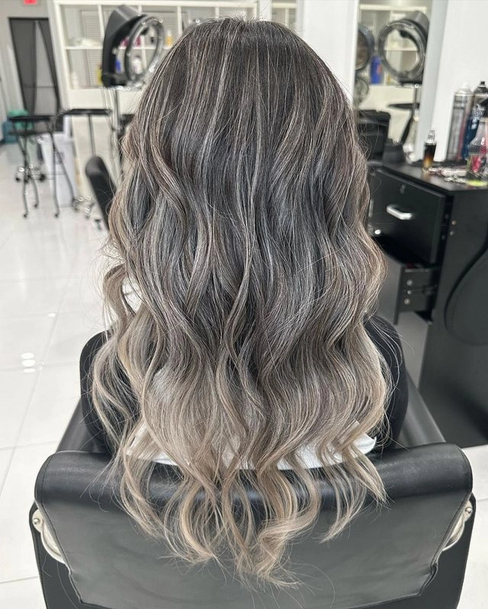 Elegant prom hairstyle showcasing ash blonde highlights with soft curls