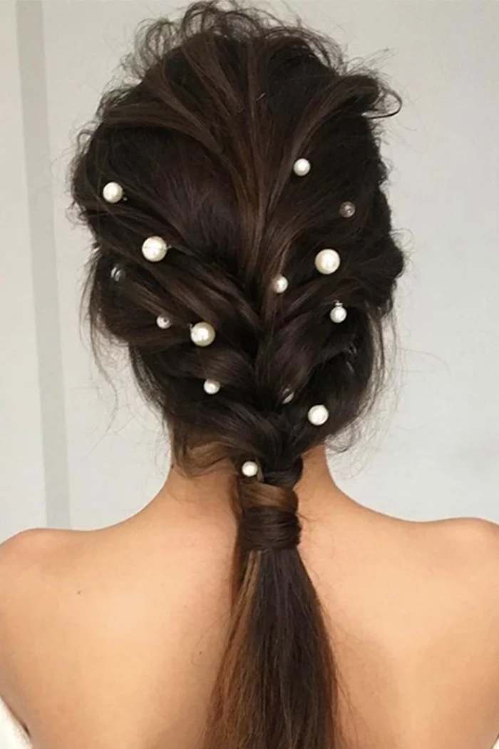 Elegant prom hairstyle featuring multiple small braids woven into a chic updo