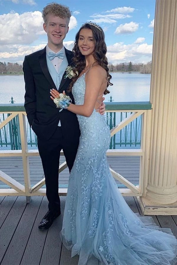 Elegant prom hairstyle featuring braided curls to match a blue dress