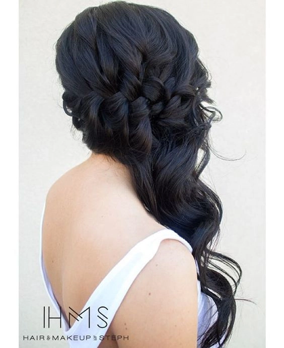 Elegant prom hairstyle featuring multiple small braids woven into a sleek updo