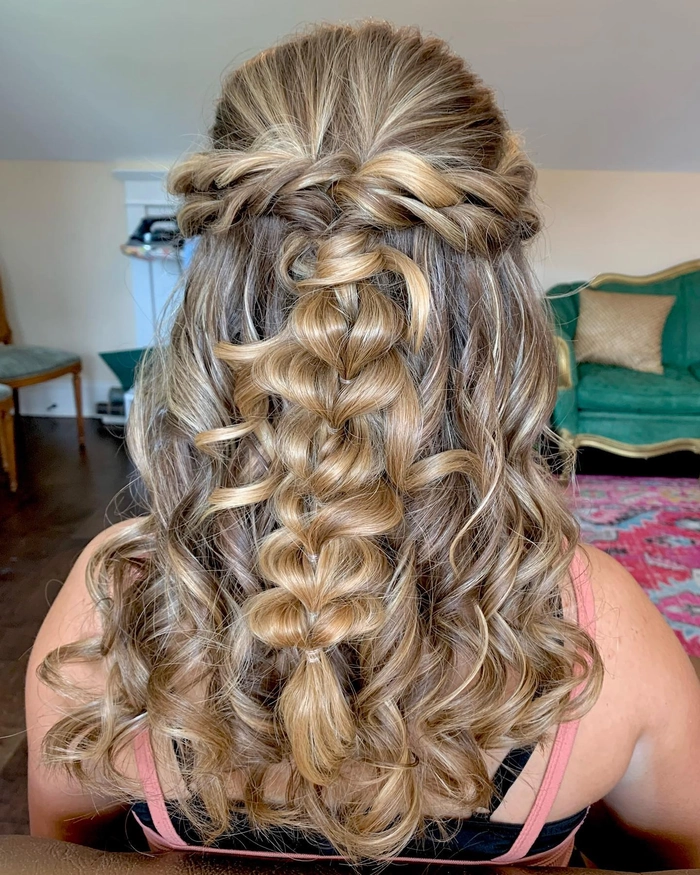 Elegant prom hairstyle featuring multiple small braids woven into a stylish updo